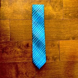 A John ashford blue white and black patterned tie.